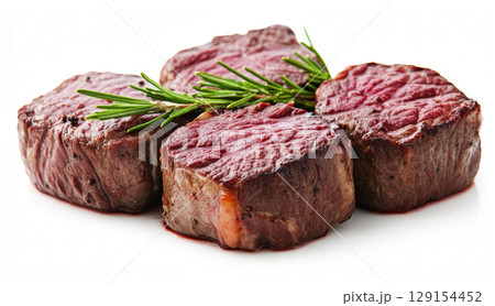Fresh raw medium rare grilled pork steaks with rosemary sprig cooking food isolated on white background 129154452