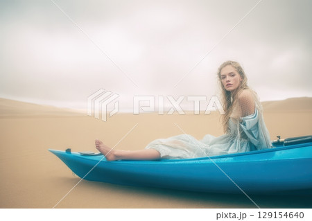 Experience the Serene Beauty of a Kayak Gliding Amidst the Tranquil Desert Sands and Views 129154640