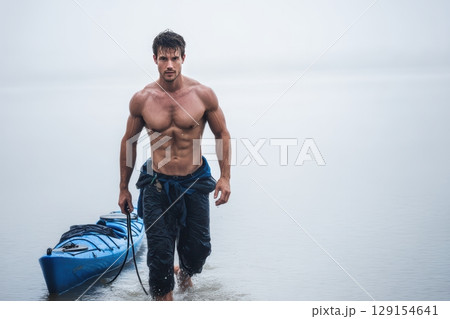 A person kayaking in a misty lake, immersed in natures beauty, enjoying tranquility and adventure 129154641
