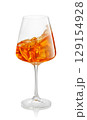 glass of aperol spritz cocktail splashing inside isolated on white background 129154928
