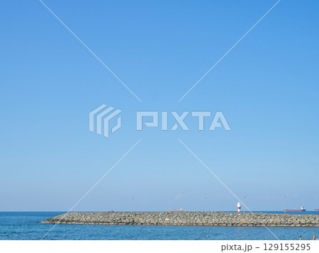 Sea coast against the backdrop of the city.  Rocky shore of the Black Sea. Seaside holiday concept 129155295
