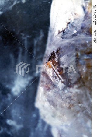 Beautiful close up of quartz crystal rock shard with reflective rainbow spiritual light 129155349