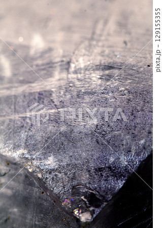 Beautiful close up of quartz crystal rock shard with reflective rainbow spiritual light 129155355