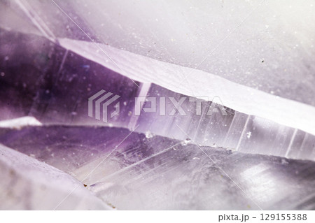 Beautiful close up of quartz crystal rock shard with reflective rainbow spiritual light 129155388