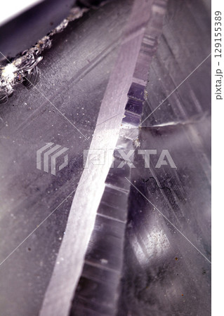 Beautiful close up of quartz crystal rock shard with reflective rainbow spiritual light 129155389