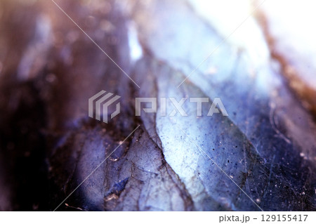 Beautiful close up of quartz crystal rock shard with reflective rainbow spiritual light 129155417