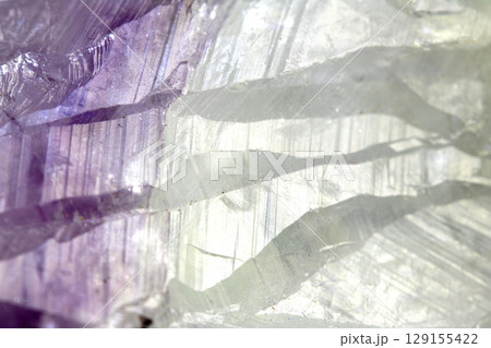 Beautiful close up of quartz crystal rock shard with reflective rainbow spiritual light 129155422