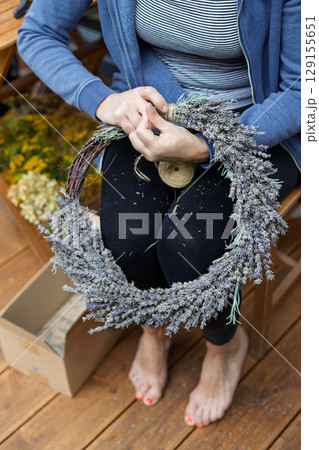 Barefoot Woman Working on Lavender Wreath Barefoot Woman Working on Lavender Wreath 129155651