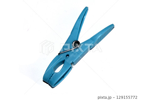 Colourful vibrant clothes pegs on a white background close up for laundry day 129155772