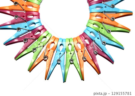 Colourful vibrant clothes pegs on a white background close up for laundry day 129155781