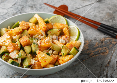 Rujak or rojak is a salad dish of a mixture of sliced fruit and vegetables and served with a spicy palm sugar dressing closeup in the bowl. Horizontal Rujak or rojak is a salad dish of a mixture of sliced fruit and vegetables and served with a spicy palm sugar dressing closeup in the bowl. Horizontal 129156822