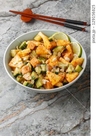 Rojak fruit vegetable salad with tofu cheese close-up in a bowl. Vertical Rojak fruit vegetable salad with tofu cheese close-up in a bowl. Vertical 129156825