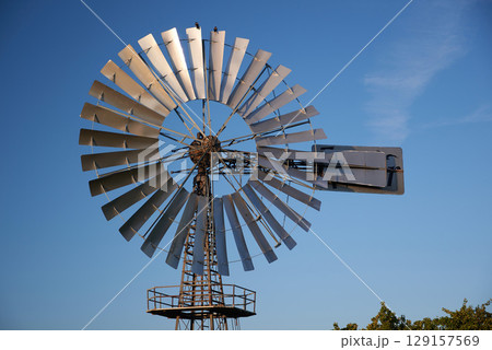 windmill used for regulationof water flow in agriculture as water pump 129157569