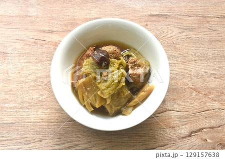 boiled pickled cabbage and bitter cucumber with tofu topping black mushroom in Chinese herb soup  129157638