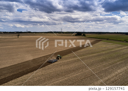 plowing farm after harvesting with vehicle plowing farm after harvesting with vehicle 129157741