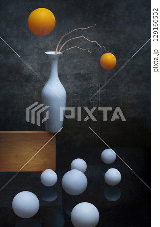 Still life with white and orange balls and white vase 129160532