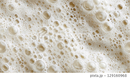 Detailed macro shot of light beige beer foam, showing various bubble sizes. Seamless tile. 129160968