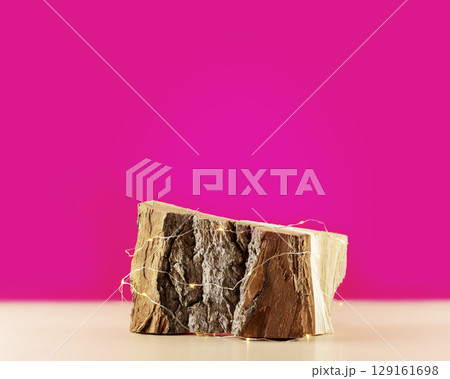 Empty wooden podium with lightening on a pink background. Product presentation. Beautiful background from natural materials for new product and promotion sale 129161698