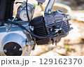 Close-up shot of a motorcycle engine, displaying its intricate mechanical components and design with precision and detail 129162370