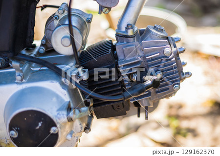 Close-up shot of a motorcycle engine, displaying its intricate mechanical components and design with precision and detail Close-up shot of a motorcycle engine, displaying its intricate mechanical components and design with precision and detail 129162370