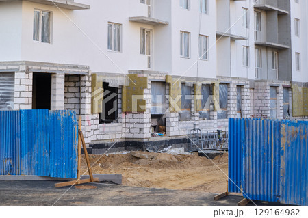 A busy urban construction site with multiple new residential buildings being built A busy urban construction site with multiple new residential buildings being built 129164982