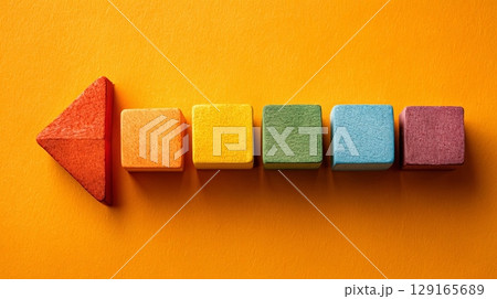 Colorful Wooden Blocks on Vibrant Orange Background 129165689