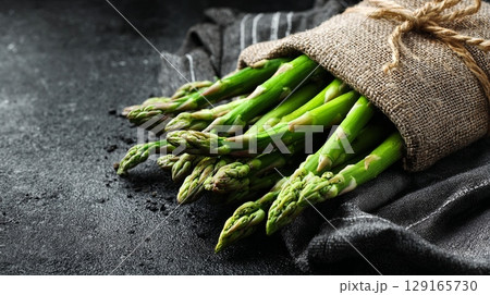 Fresh Green Asparagus Bundle on Dark Background Fresh Green Asparagus Bundle on Dark Background 129165730