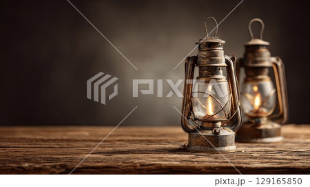 Vintage Oil Lanterns on Rustic Wooden Table 129165850