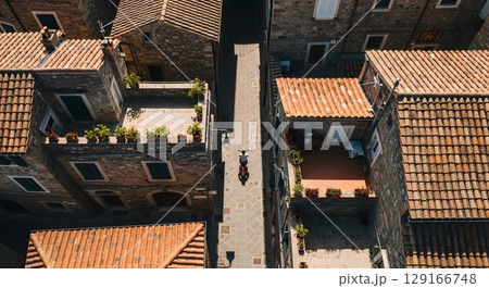 Aerial View of a Terracotta Rooftop Alleyway in an Italian Old Town during Daylight 129166748