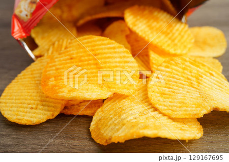 Potato chips , delicious BBQ seasoning spicy for crips, thin slice deep fried snack fast food. 129167695