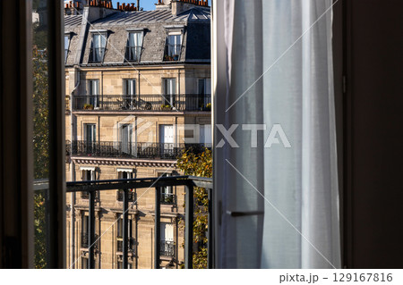 Open window overlooking the city with old buildings Open window overlooking the city with old buildings 129167816