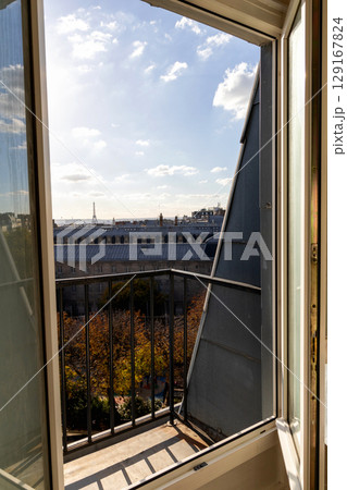 Open window with view of rooftops and Eiffel Tower in Paris, France Open window with view of rooftops and Eiffel Tower in Paris, France 129167824