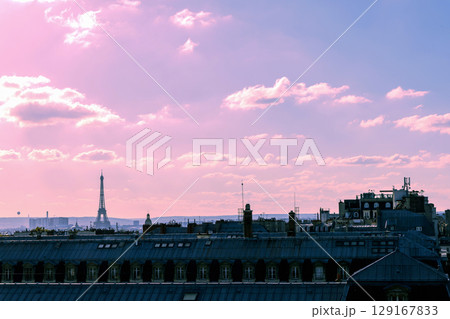 Romantic view of rooftops and Eiffel Tower with the sunset sky in Paris, France Romantic view of rooftops and Eiffel Tower with the sunset sky in Paris, France 129167833