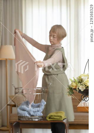 家事をするシニア女性　洗濯物と高齢者女性 129168329