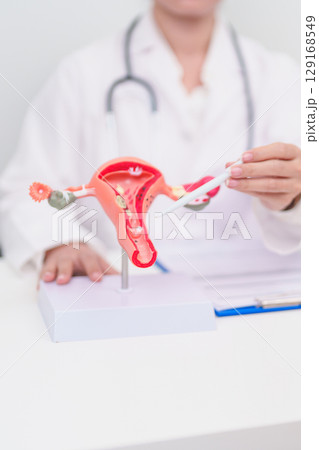 Woman patient consulting doctor with anatomy Uterus and Ovaries. Ovarian and Cervical cancer, Cervix disorder, Endometriosis, Hysterectomy, Uterine fibroids, Reproductive system and Pregnancy concept Woman patient consulting doctor with anatomy Uterus and Ovaries. Ovarian and Cervical cancer, Cervix disorder, Endometriosis, Hysterectomy, Uterine fibroids, Reproductive system and Pregnancy concept 129168549