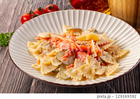 Italian pasta farfalle with salmon 129169392