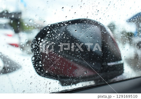 side mirror of car in rainy day, water drop on glass side mirror of car in rainy day, water drop on glass 129169510