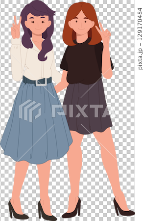 two young stylish women smiling with peace signs 129170484
