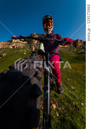 Vertical photo of young athlete view from above wide angle. Professional rider on mountain bike 129173868