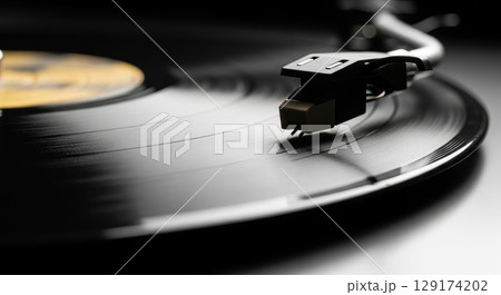 Vintage Turntable with Stylus Playing Vinyl Record in Studio 129174202