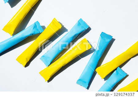 Yellow and blue stick pack energy drink and instant coffee mockup. 129174337