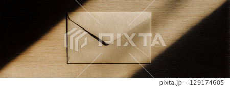 Mysterious Envelope Under Spotlight in Dark Room 129174605
