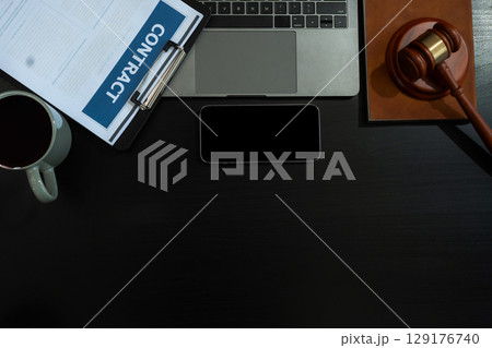 Justice and law concept.Lawyer workplace with laptop and documents with dark wooden in office. Justice and law concept.Lawyer workplace with laptop and documents with dark wooden in office. 129176740