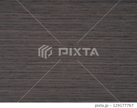 Dark dove grey shades stretch over the textured expanse of oak veneer Dark dove grey shades stretch over the textured expanse of oak veneer 129177767