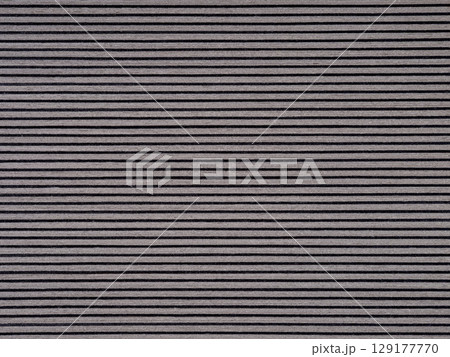 Sleek gray veneer surface with fine, uniform dark striations Sleek gray veneer surface with fine, uniform dark striations 129177770