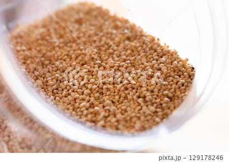 Close-up of raw quinoa in a glass jar. Superfood. Storage concept 129178246