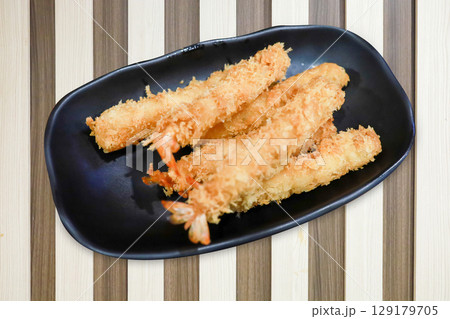 shrimp in tempura on brawn color wood strip background 129179705