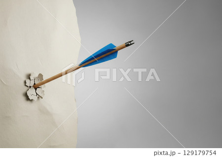 An arrow pierces the wall. Space for text. An arrow pierces the wall. Space for text. 129179754