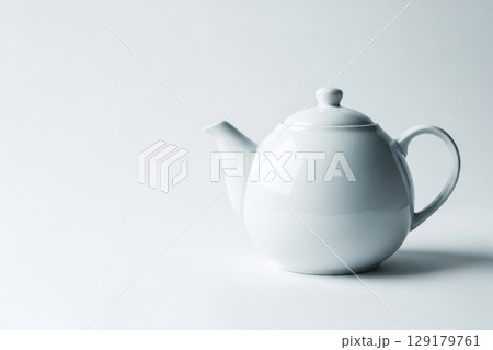 A white kettle on a clean background in a studio light. Space for text. 129179761