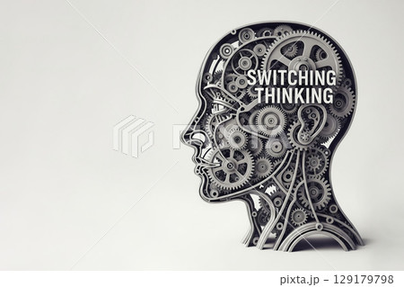 A mechanical head consisting of gears with the inscription Switching Thinking. Space for text. 129179798